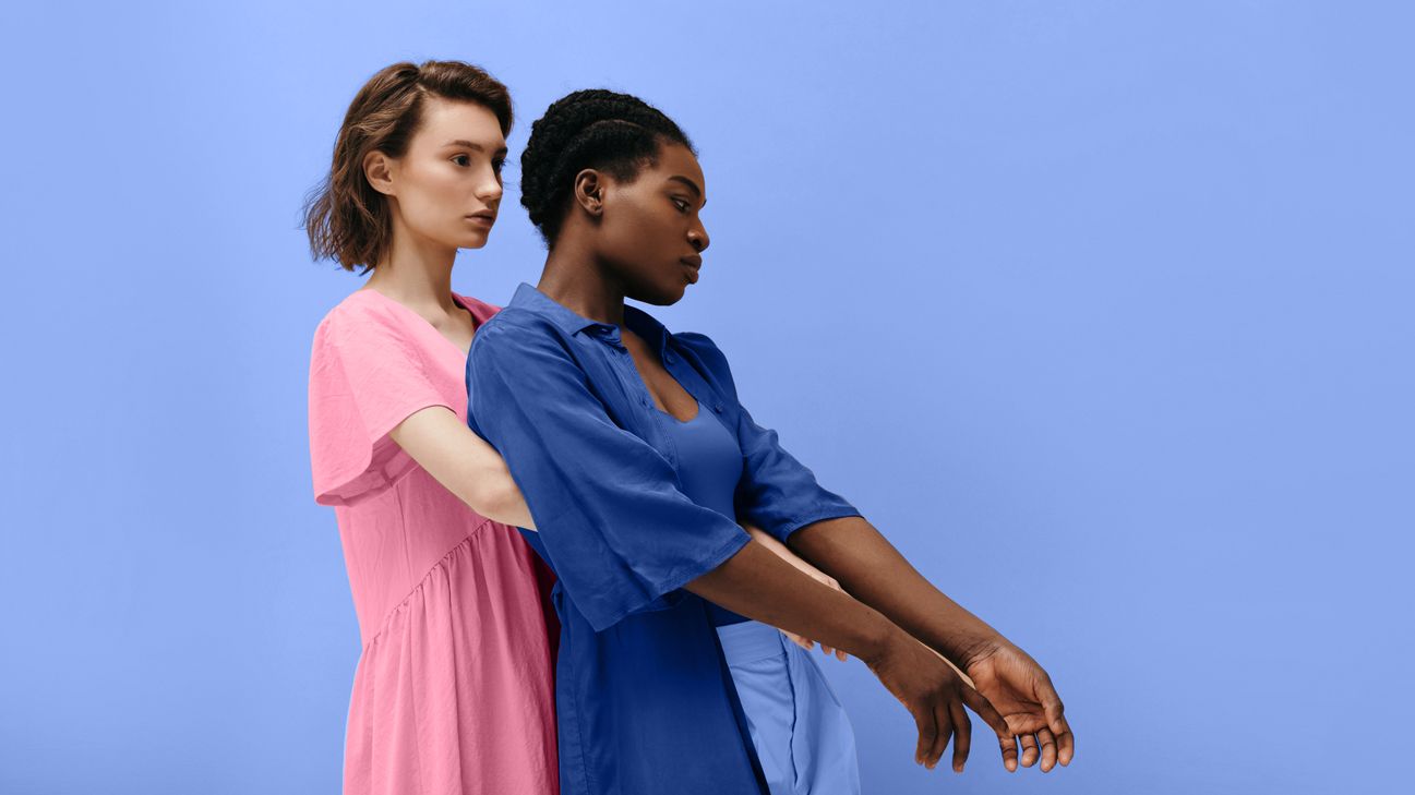 Two young women embracing back to front